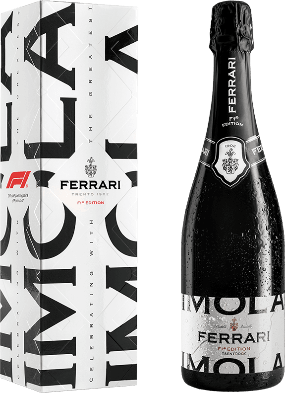 Het label van de wijnfles is minimalistisch en modern, met grote zwarte letters die het woord 'IMOLA' vormen. Bovenaan het label staat in kleinere letters 'FERRARI' en daarboven een familiewapen of schild. Er zijn ook kleine rode accenten aanwezig, zoals de tekst 'F1® EDITION'.